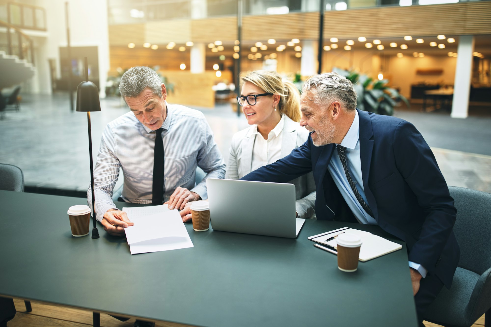 Mature executives meeting in the lobby of an office building