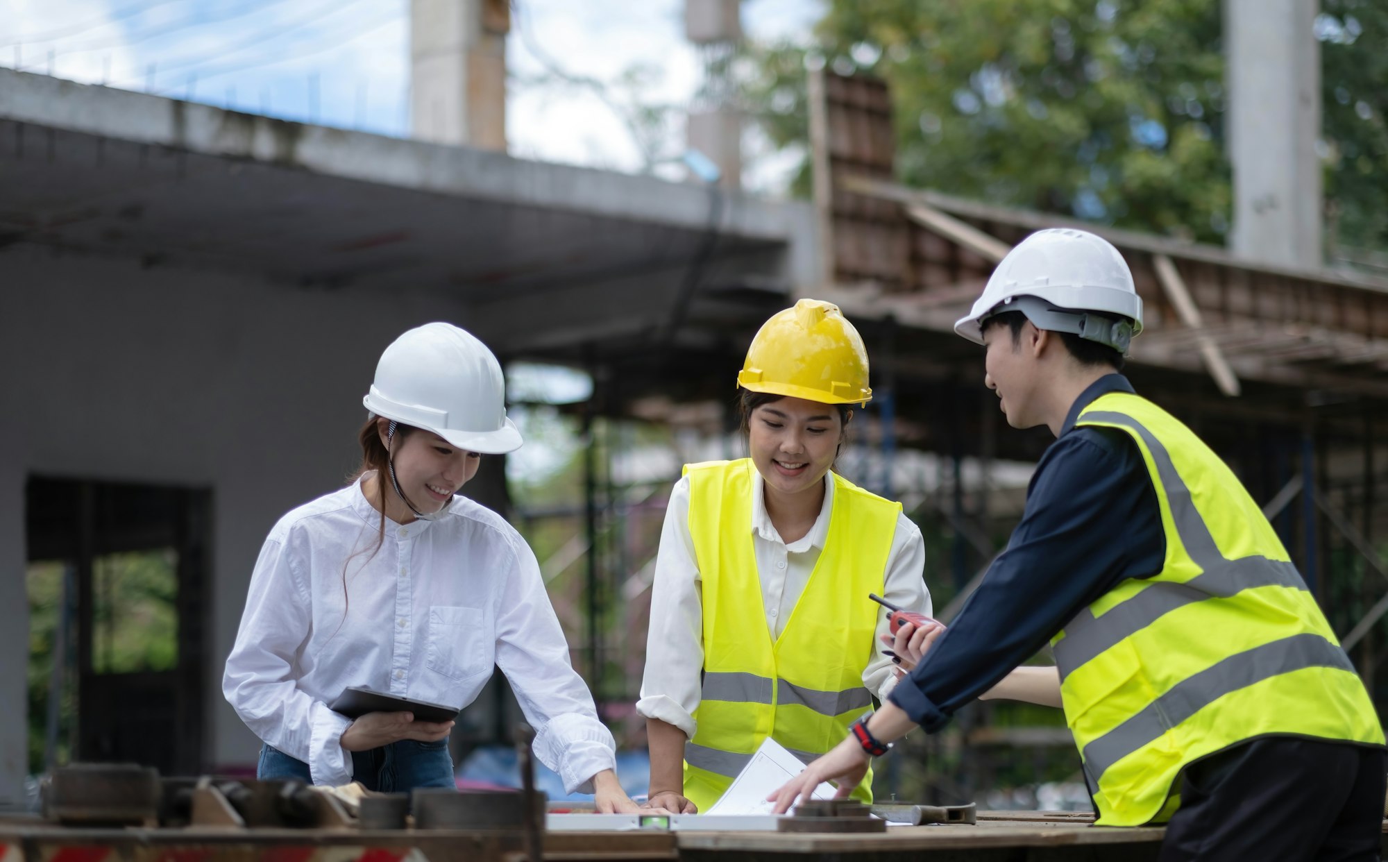 Three experts inspect commercial building construction sites, industrial buildings real estate