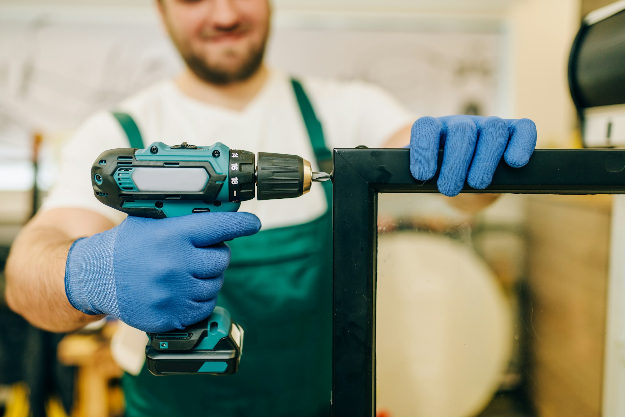 Worker with screwdriver repairs refrigerator door